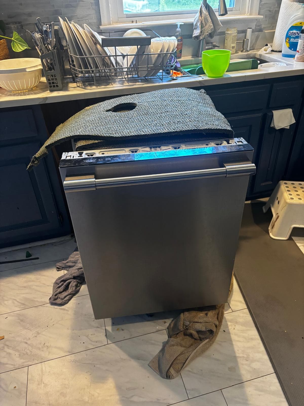 Built-in dishwasher pulled from kitchen cabinet for repair in Connecticut — control panel open with diagnostic indicator light active