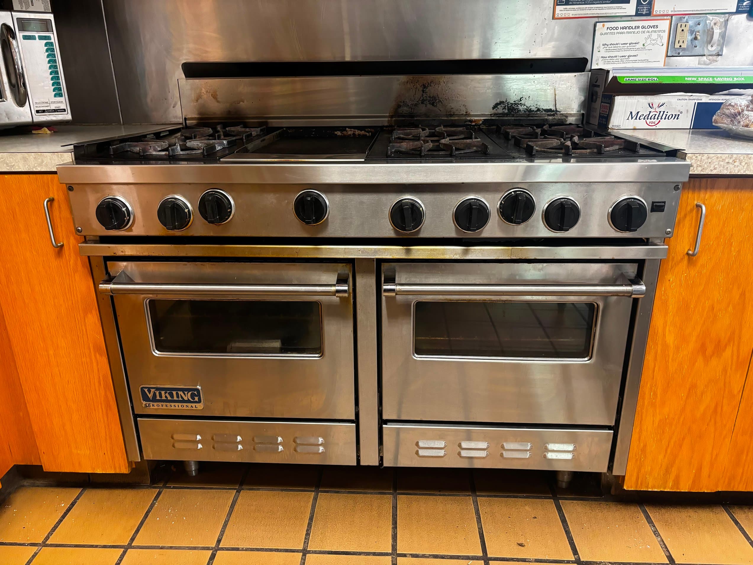 Viking Professional 48-inch commercial gas range with double oven serviced by Connecticut appliance repair technician — burner and ignition inspection